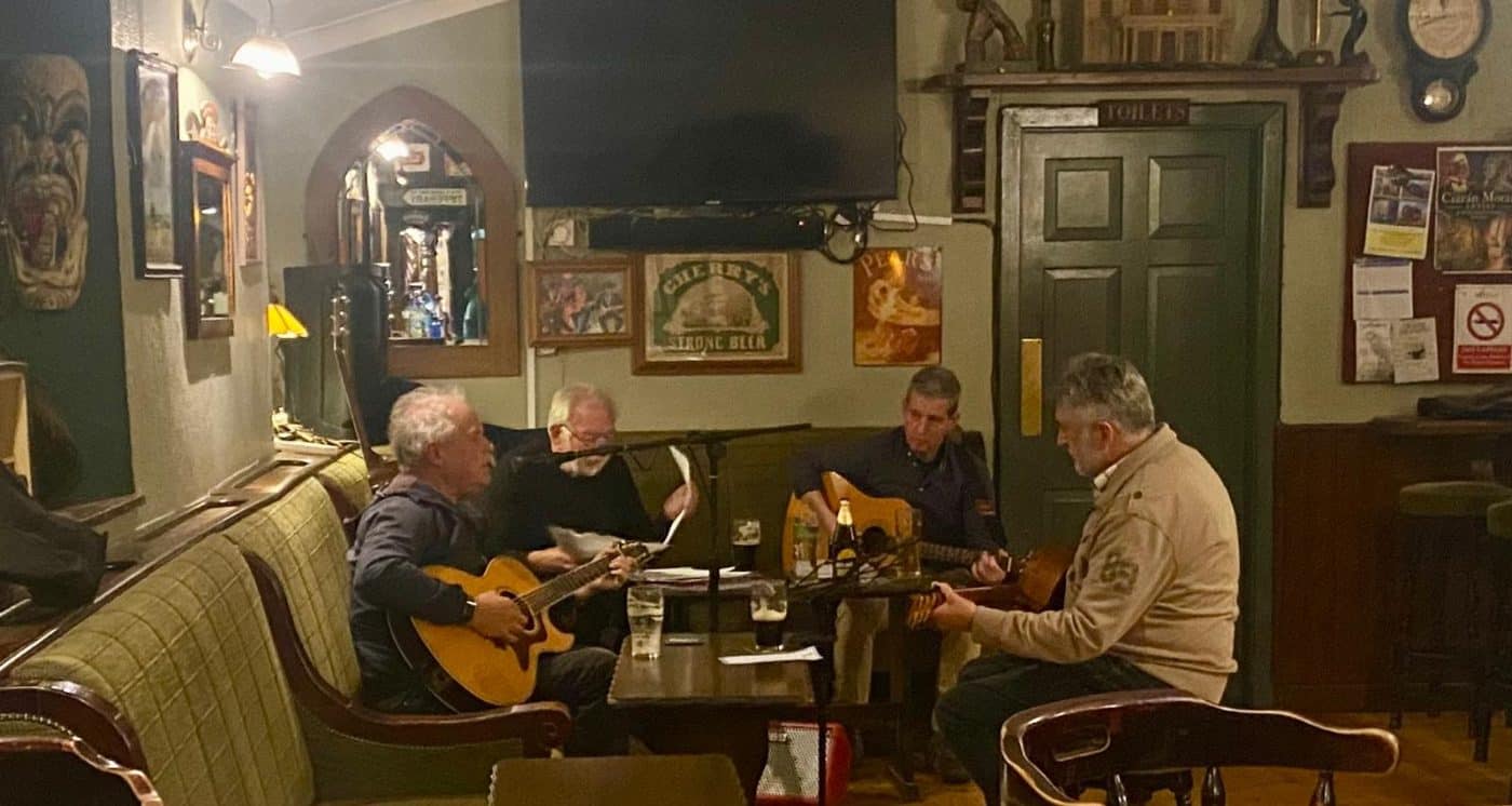 Musicians playing acoustic guitars at the Theatre Sessions in the Theatre Bar, New Ross